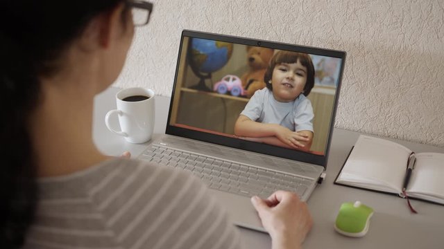 Video Call. Distance Education. Little Child Video Call Via Laptop Talking to Mom. Online Tutor, Mother, Pediatrician Talking With Kid Video Calling Using Computer. Home Conference Children Education.