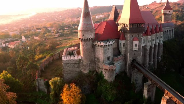 Famous attraction gothic Corvin Castle in Hunedoara Transylvania, Romania in autumn - aerial view from above