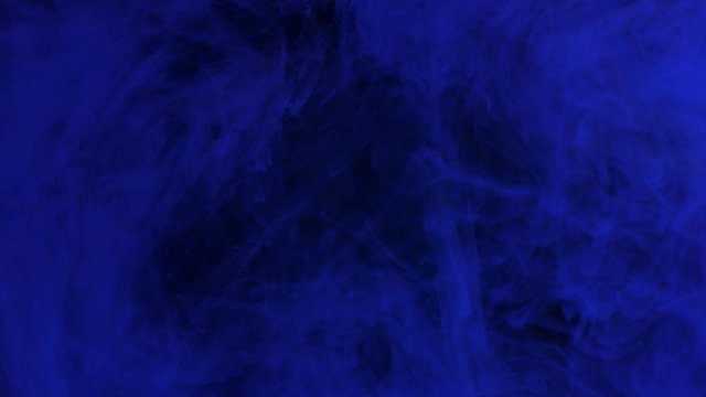 Dark blue ink mixing in water, swirling softly underwater with copy space. Colored acrylic cloud of paint isolated. Colorful abstract smoke explosion animation. Universe, space. Art background. 4K