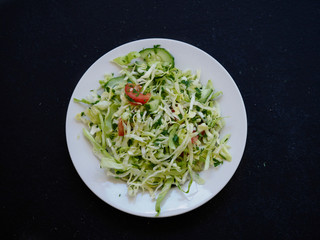 Cabbage salad and tomato on a plate. Dietary salad with fresh vegetables