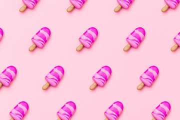 Trendy sunlight Summer pattern made with pink ice cream on pastel light pink background. Minimal summer food concept. Flat lay.