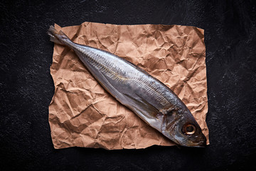 Horse mackerel on a table on craft paper.