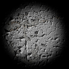 Background looks like round fragment a wall covered with cracked old paint with a vignette. Details of architecture and temporary building structures.