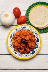 Mexican sausage with chipotle sauce on white background