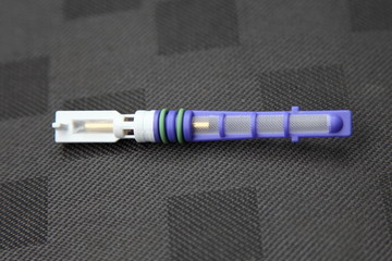 Car conditioner orifice tube valve replaceable freon filter close up, automobile A/C maintenance