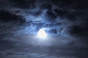 Naklejka na ściany i meble Full Mooon dark sky under dramatic clouds, magic moonlight beautiful cloudscape