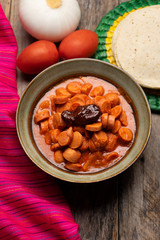 Mexican sausage with chipotle sauce on wooden background