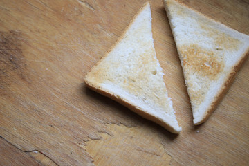 Two pieces of bread on a wooden table