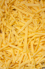 Grated hard cheese for homemade pizza. Russian, Dutch cheese. Grated cheese in  macro
