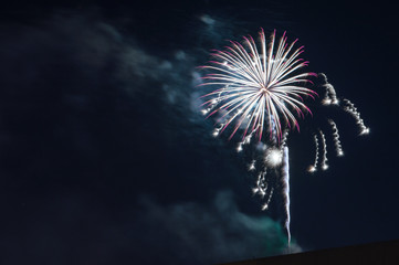 Fireworks light up the sky. Fireworks display on dark sky background. Celebration concept