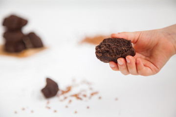 Child's hand holding buckwheat flour cookie
