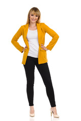 Fototapeta premium Woman In Yellow Jacket Is Standing With Hands On Hip