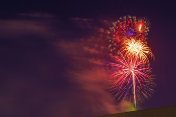 Fireworks light up the sky. Fireworks display on dark sky background. Celebration concept