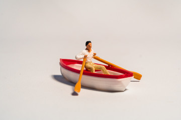 miniature figure of kayaking, rowing the boat