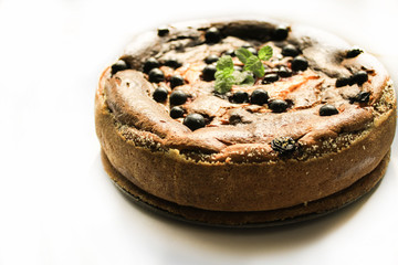 Pie with berries on a white windowsill