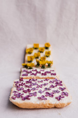 3 sandwiches with yellow and pink flowers