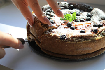 Pie with berries on a white windowsill
