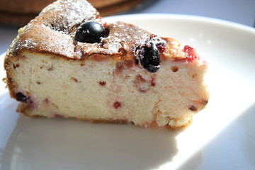 Pie with berries on a white windowsill