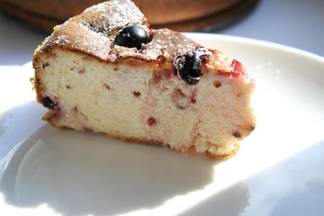Pie with berries on a white windowsill