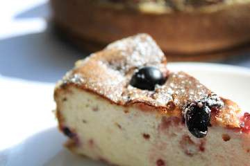 Pie with berries on a white windowsill