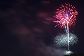 Fireworks light up the sky. Fireworks display on dark sky background. Celebration concept