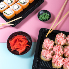 Philadelphia and lava rolls in a black boxes with chopsticks. Food delivery