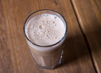 glass of cappuccino on a wooden table