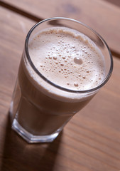 glass of cappuccino on a wooden table