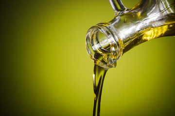 Olive oil  flowing to the spoon