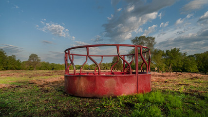 Cattle round bale feeder on a spring day, no hay or cows © Tamara  Harding