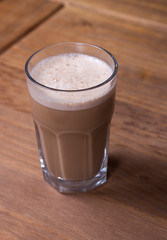 glass of cappuccino on a wooden table