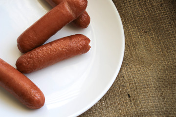 Fried sausages on a white plate