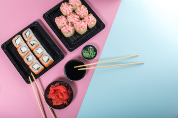 Philadelphia and lava rolls in a black boxes with chopsticks. Food delivery
