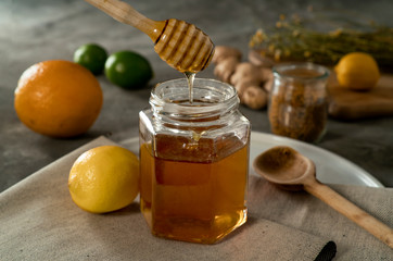 honey jar draining with citrus, pollen and ginger