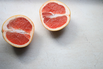 Sliced grapefruit on a light background