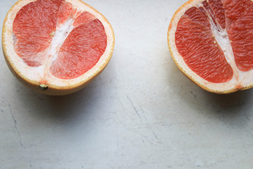 Sliced grapefruit on a light background