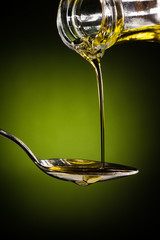 Olive oil  flowing to the spoon
