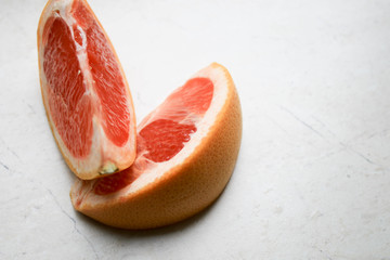 Pieces of grapefruit on a gray background