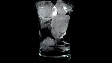 Close-up of melting ice cubes on black background