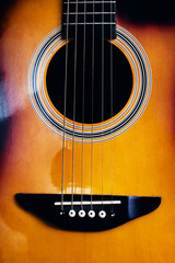 Darkness inside an acoustic guitar close up