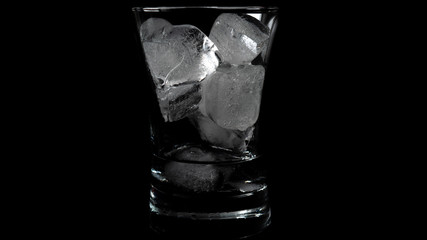 Close-up of melting ice cubes on black background