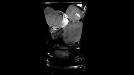 Close-up of melting ice cubes on black background