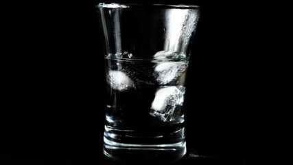 Close-up of melting ice cubes on black background