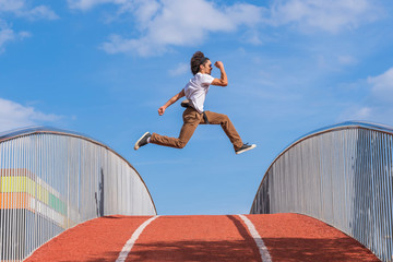 Dancer jumping on bridge, mid air
