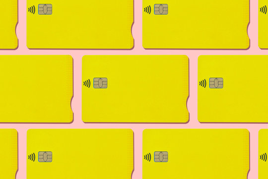 Yellow contactless credit cards pattern on pink background