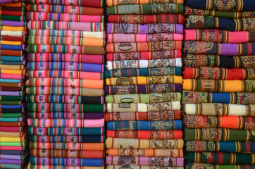 A stack of colorful Andes textiles. These type of fabrics can be found in Bolivia, Ecuador, Argentina and Peru.