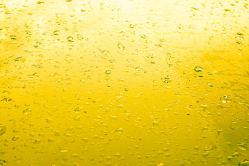 Drops after rain on a lemon background