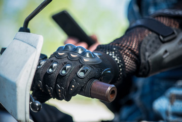 Motor biker hand on a motorcycle steering wheel close up.