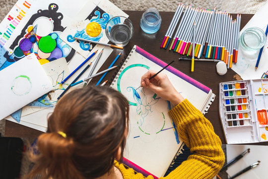 Woman painting with watercolours, top view