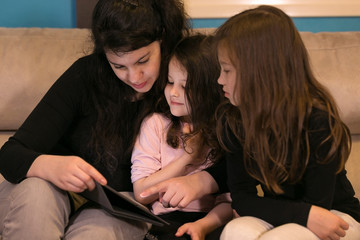 Mother doing Lessons with Children on a Tablet